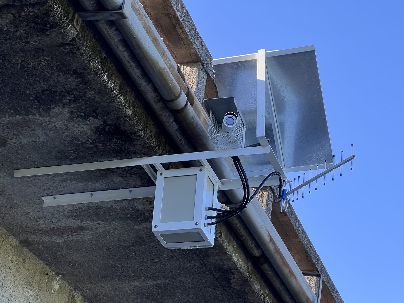 The fixed LSPIV station on the Matanza river: camera, solar panel and equipment cabinet mounted under the bridge